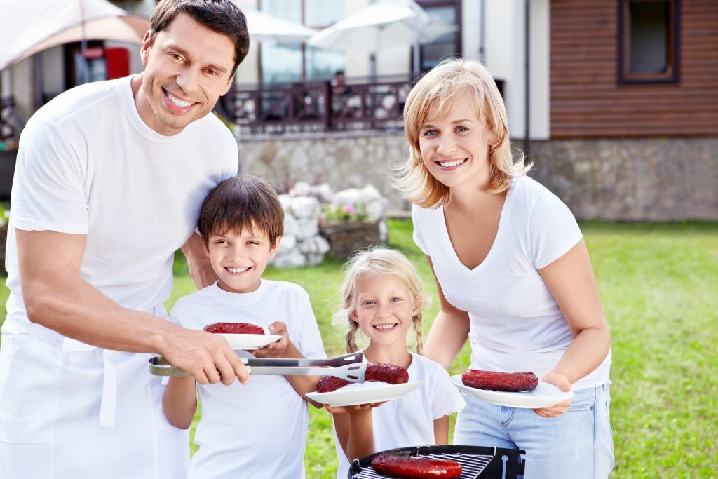 Smiling family with children at barbecue